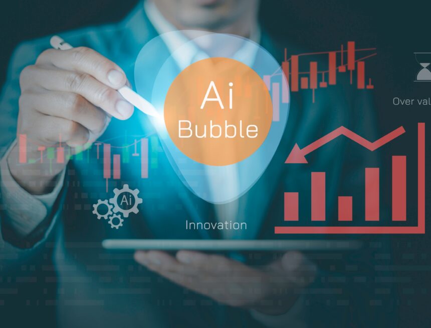 Concept graphic image illustrates "AI bubble" hovering above a laptop and directed by a businessman with a stylus alongside graphs.