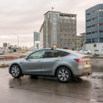 A Silver Tesla Model Y Operating As A Taxi In Reykjavík, Iceland.