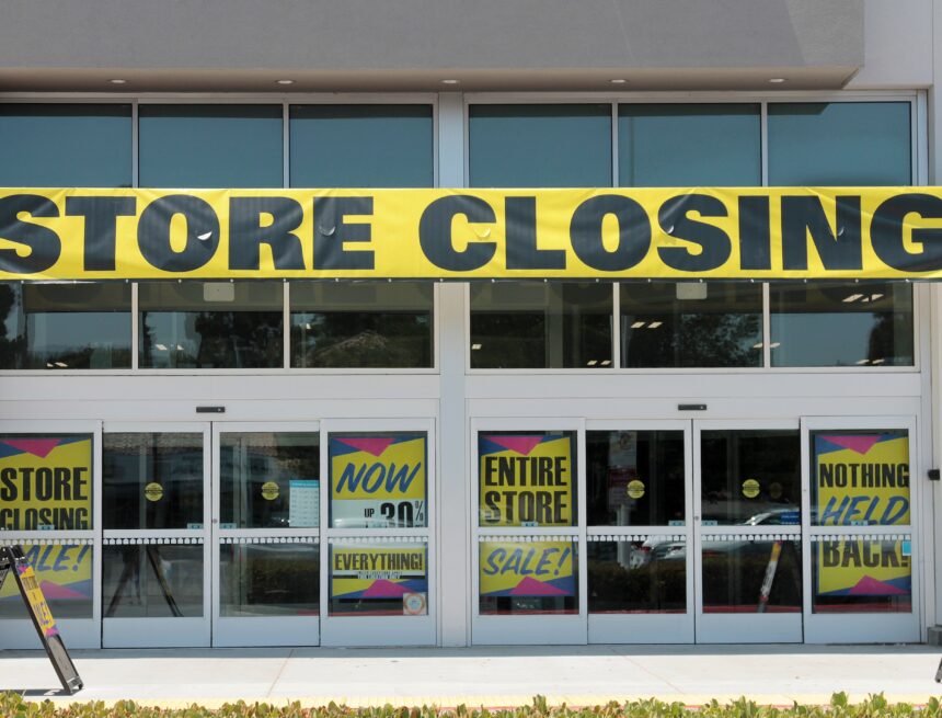 A retail storefront displaying multiple "Store Closing" and liquidation sale signs in Lake,Forest, California. A retail storefront displaying multiple "Store Closing" and liquidation sale signs in Lake,Forest, California.