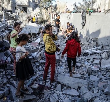 Palestinian children walk on the rubble of destroyed buildings in the Gaza Strip.