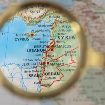 A close-up, magnified view of a political map focused on the Eastern Mediterranean region which highlights several countries and territories, including Syria, Lebanon, Israel, Jordan, Cyprus, and southern Turkey and key cities such as Damascus, Beirut, Amman, Nicosia, and Jerusalem.