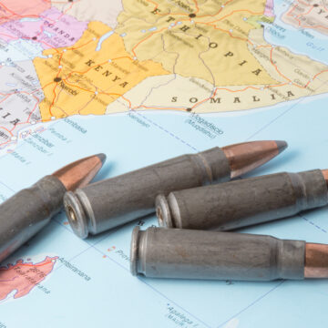 Four rifle cartridges/bullets placed on a map of East Africa featuring countries such as Somalia, Ethiopia, Kenya, and Tanzania.