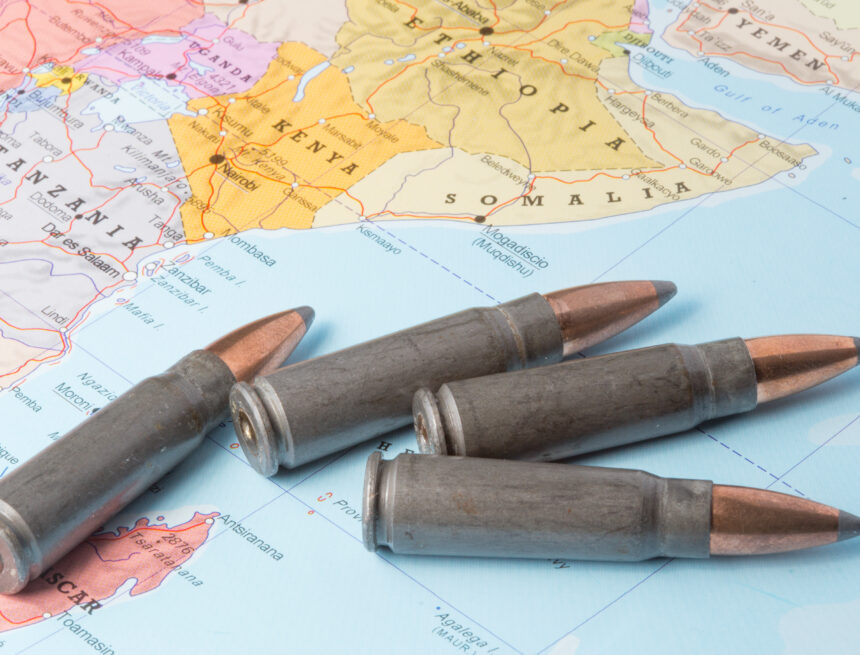 Four rifle cartridges/bullets placed on a map of East Africa featuring countries such as Somalia, Ethiopia, Kenya, and Tanzania. Four rifle cartridges/bullets placed on a map of East Africa featuring countries such as Somalia, Ethiopia, Kenya, and Tanzania.