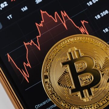 A smartphone showing the world's largest cryptocurrency, Bitcoin, and the price chart indicating a recent price of approximately $18,304.62, showing a significant decline.