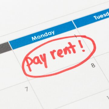 Image Of A Calendar With The Message "Pay Rent!" Circled In Red Ink On The 1st Of The Month.