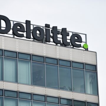 A Photo Of The British Multinational Deloitte Building, With Logo On Top, In Berlin, Germany.