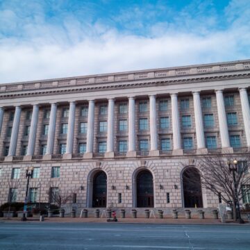 A Photo Of The Internal Revenue Service (IRS) Headquarters In Washington, D.C. Located on Constitution Avenue NW. It Is A Large, Classical-style Building With Numerous Columns Across Its Facade.