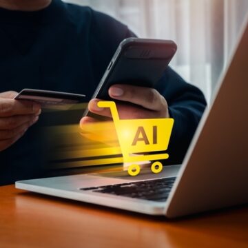 Concept image of AI in e-commerce, showing a shopping cart icon labeled "AI" moving from a mobile device to a laptop.