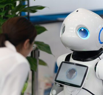 A lady interacts with a humanoid service robot at a technology exhibition in Chongqing, China.