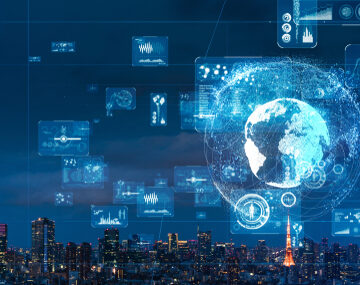 Technological concept of a digital globe over a city skyline representing industrial automation, global connectivity and data exchange.