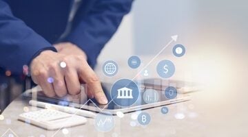 A business professional using a tablet for digital banking activities, featuring holographic icons representing financial data, security, and transactions. A business professional using a tablet for digital banking activities, featuring holographic icons representing financial data, security, and transactions.