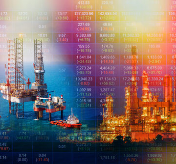 A double exposure photo that combines an aerial view of an offshore oil rig platform in a gulf with a digital overlay of stock market price changes.
