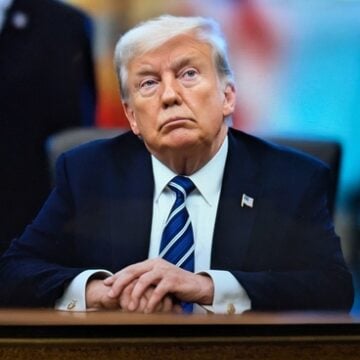 President Trump Sitting At a Desk In the Roosevelt Room in the White House
