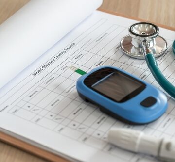 A diabetic kit, used to measure the amount of glucose in the blood and essential for managing diabetes, includes a blood glucose monitor, a lancing device, and a stethoscope.