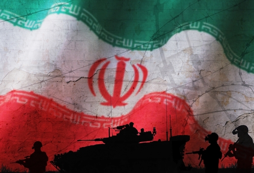 Concept image of the green, white, and red flag of the Islamic Republic of Iran, with silhouettes of soldiers and armored vehicles in the foreground.