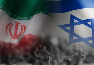 Concept image features the national flags of Iran and Israel superimposed over an image of military silhouettes.