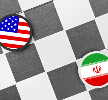 Concept image of a chess or checkers board using the flags of the United States and Iran as pieces on the board.
