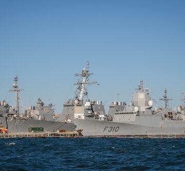 Navy vessels from the U.S., Spain, and Norway, commonly seen during joint NATO exercises, docked at the Norfolk Naval Base, Virginia.