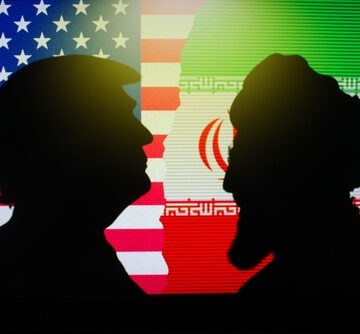 A silhouette of Donald Trump facing a bearded figure wearing a turban against a backdrop of the American and Iranian flags.