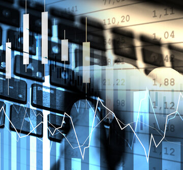This image represents financial market trading, showing candlestick charts and line graphs overlaid on a person using a computer keyboard. This image represents financial market trading, showing candlestick charts and line graphs overlaid on a person using a computer keyboard.
