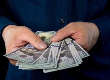 Big,Pile,Of,Money,Dollars,In,The,Hand.,Close,Up INVESTORS TAKE REFUGE IN CASH AS ECONOMIC WORRIES MOUNT