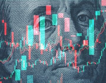 Financial candlestick charts superimposed onto a US one-hundred-dollar bill featuring Benjamin Franklin.