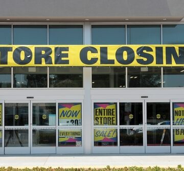A retail storefront displaying multiple "Store Closing" and liquidation sale signs in Lake Forest, California.