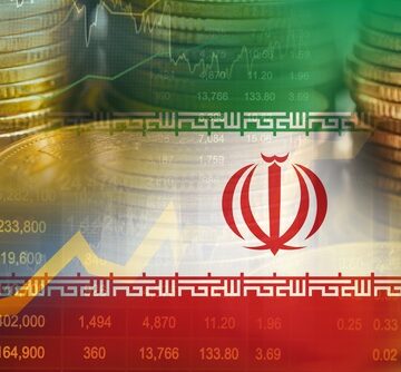 Double exposure of stacks of coins, the Iranian flag, and stock market data.