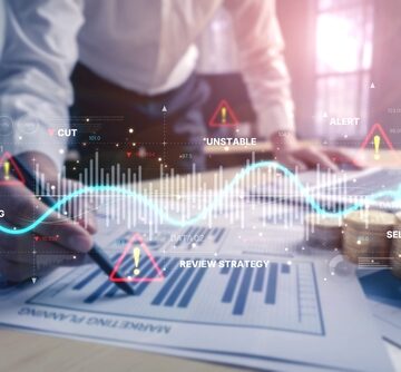 Conceptual digital overlay of financial documents being analyzed by a business professional along with graphs and data.