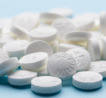 A pile of aspirin tablets, which are commonly used as an analgesic, antipyretic, and anti-inflammatory medication.