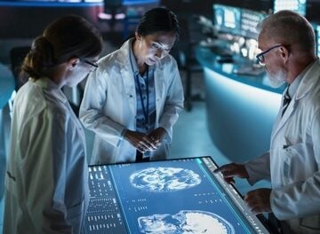 Modern,Hospital,Medical,Research,Center:,Diverse,Colleagues,Gathered,Around,Interactive NEW CANCER TREATMENT ATTACKS TUMORS