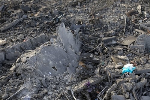 A large decimated area covered in rubble, shattered concrete, and twisted rebar.