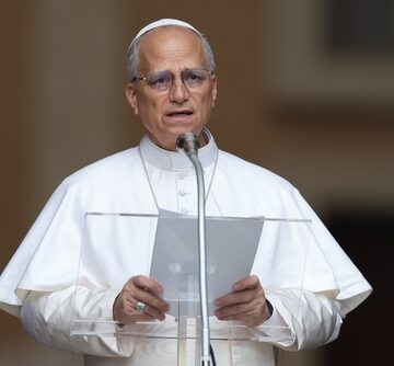 Pope Leo XIV addressing the public from a lectern in Castel Gandolfo, Italy, the traditional summer residence of the Pope.