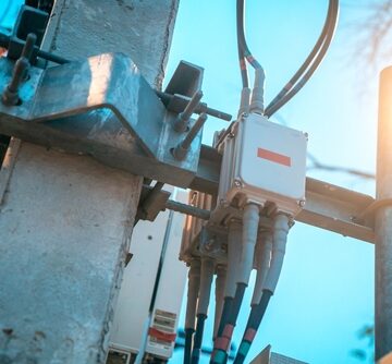 Close-up view of a utility pole featuring various communication infrastructure equipment, commonly used for cellular network expansion.