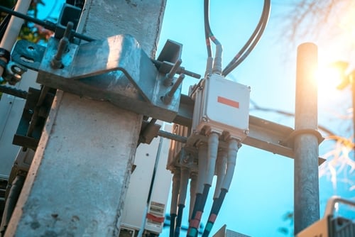 Close-up,View,Of,A,Utility,Pole,Featuring,Various,Equipment,And Close-up view of a utility pole featuring various communication infrastructure equipment, commonly used for cellular network expansion.