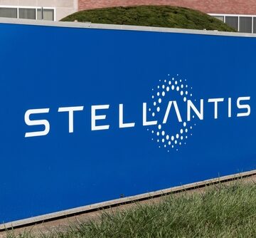 A large exterior sign with the logo for Stellantis, a major automotive manufacturer formed by the merger of Fiat Chrysler Automobiles and the PSA Group.