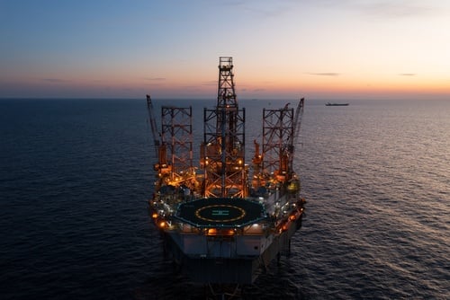Aerial,View,From,A,Drone,Of,Big,Jack,Up,Offshore Aerial view of an offshore jack-up drilling rig at sunset, often used for exploration and development in the oil and gas industry.