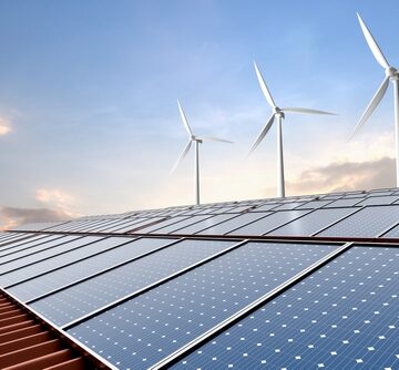 A combination of renewable energy technologies used together to generate clean electricity – solar photovoltaics, panels on a building roof that convert sunlight directly into electricity using semiconductor materials; and wind turbines which harness kinetic energy from the wind to spin generators, producing power.