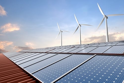 A combination of renewable energy technologies used together to generate clean electricity – solar photovoltaics, panels on a building roof that convert sunlight directly into electricity using semiconductor materials; and wind turbines which harness kinetic energy from the wind to spin generators, producing power.
