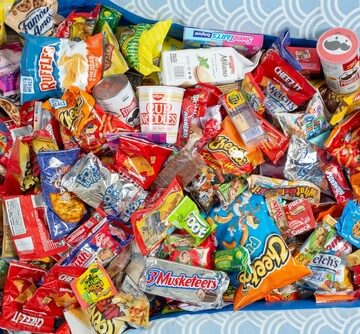 This is a pile of various brand-name junk food and snacks, including chips, candies, and chocolate bars.