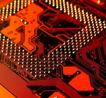 Macro,Photo,Of,Application,Specific,Integradet,Circuit,Package,Mounted,On A close-up, macro view of a printed circuit board (PCB).
