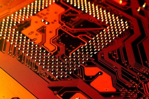 Macro,Photo,Of,Application,Specific,Integradet,Circuit,Package,Mounted,On A close-up, macro view of a printed circuit board (PCB).