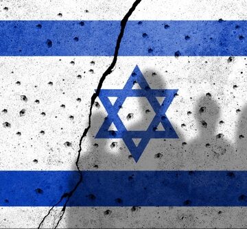 Flags,Of,Israel,State,Painted,On,The,Concrete,Wall,With The flag of Israel on a damaged concrete surface with a prominent crack running through the center of the flag and dark silhouettes of people against the flag.