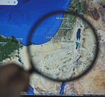 Tel,Aviv,,Israel,-,2023,October,8:,Gaza,Strip,,Palestine A digital map of the Gaza Strip and Israel on a screen, viewed through a magnifying glass to emphasize the geographic region.