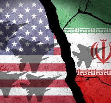 Flag,Of,Usa,And,Iran,Painted,On,A,Concrete,Wall A stylized, distressed design combining the U.S. and Iranian flags overlaid with silhouettes of military fighter jets.