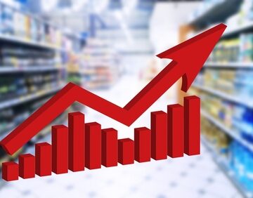A rise in grocery prices concept with a big red arrow and graph on top of an image of a grocery store aisle blurred in the background.