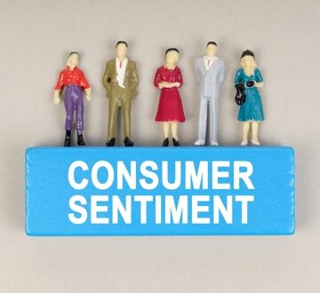 Business,Concept.,On,The,Blue,Block,The,Inscription,-,Consumer Small figures standing atop a blue box labeled "consumer sentiment."