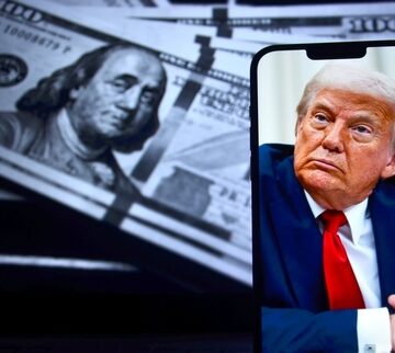 A smartphone displaying a portrait of Donald Trump with $100 bills in the background.