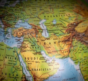 A close-up photograph of a physical globe focusing on the Middle East, including countries such as Iran, Iraq, Turkey, and Saudi Arabia. A close-up photograph of a physical globe focusing on the Middle East, including countries such as Iran, Iraq, Turkey, and Saudi Arabia.