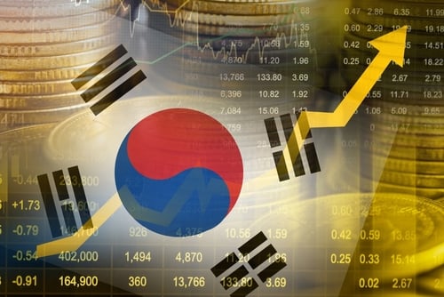 The South Korean flag with stock market data and an upward economy trend graph. The South Korean flag with stock market data and an upward economy trend graph.